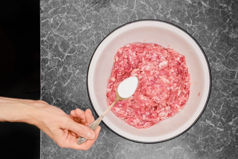 Delicious Wagyu ground beef sizzling on a grill, showcasing its rich marbling