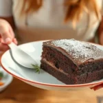 Elaborate Swiss Chocolate Chalet Cake decorated to resemble a traditional Swiss chalet with intricate chocolate details and a dusting of powdered sugar.